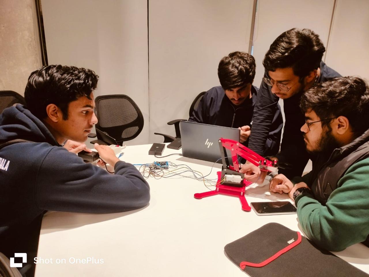 Students assembling a robotic arm